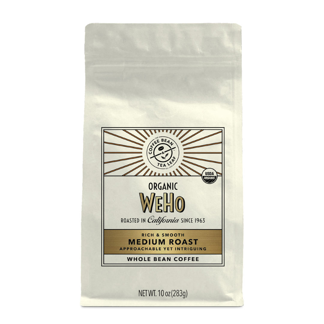 10oz cream bag labeled “WeHo” on a white background. The design shows the coffee is Roasted in California and has a Rich & Smooth taste and is Medium, Ground Coffee.