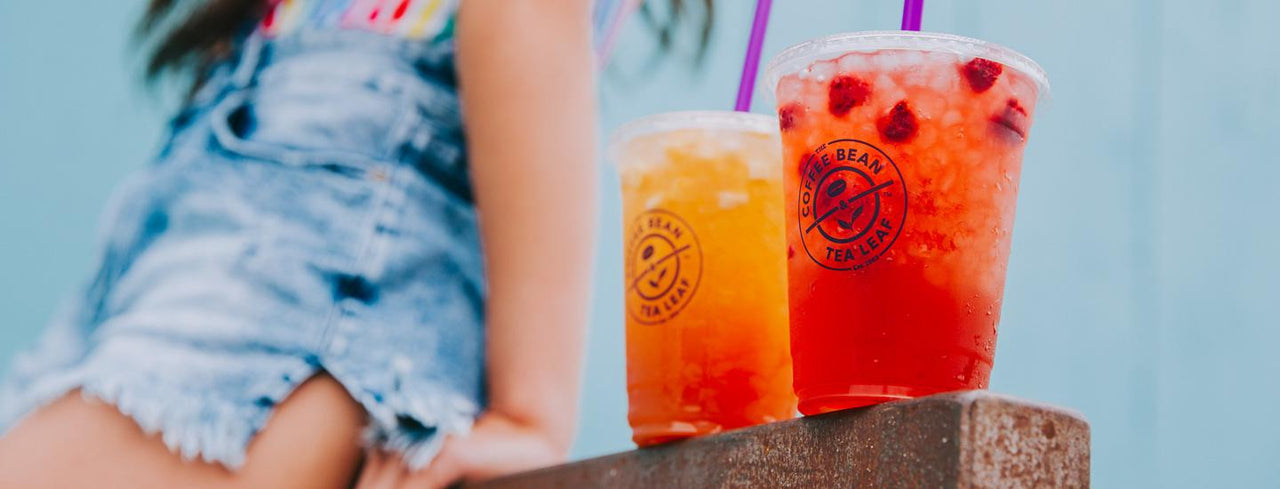 Woman with two summer tea drinks