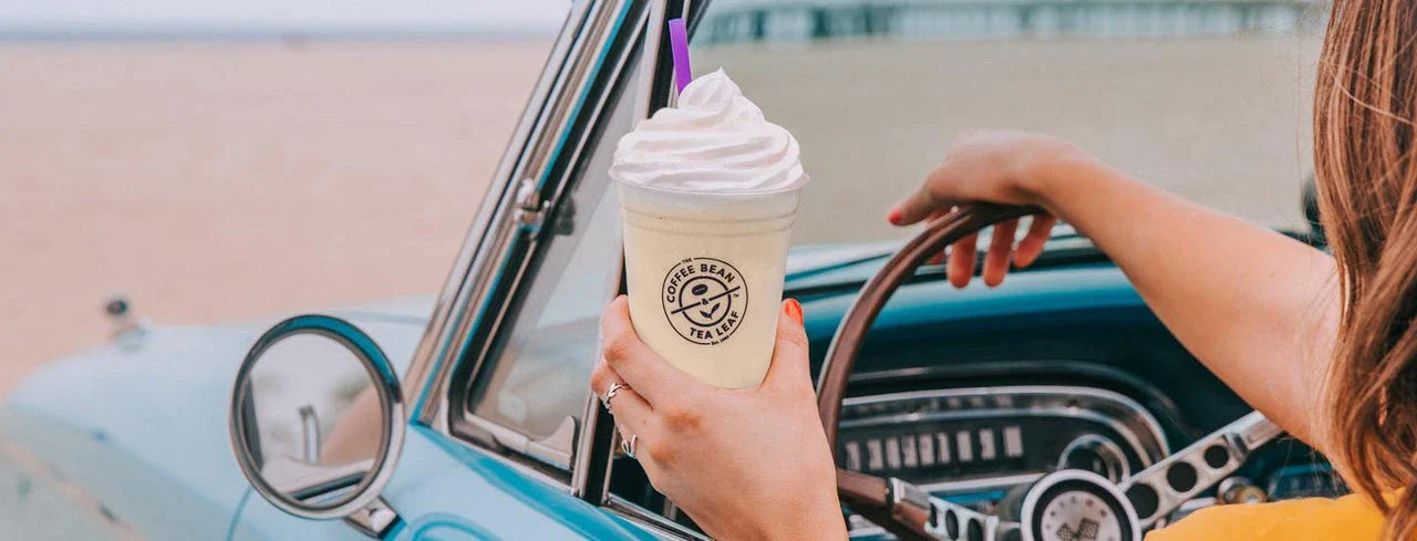 Woman Driving Car with Coffee Bean Drink