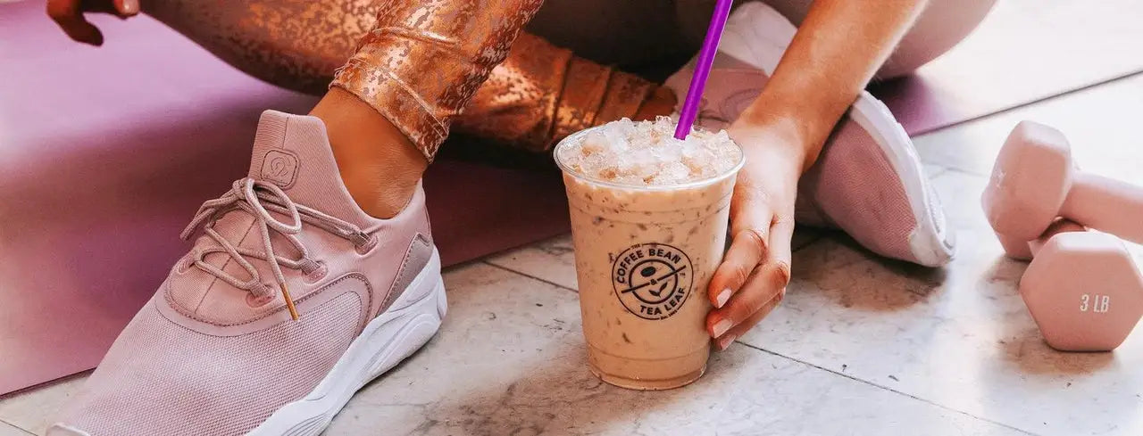 Woman on yoga mat with coffee bean drink