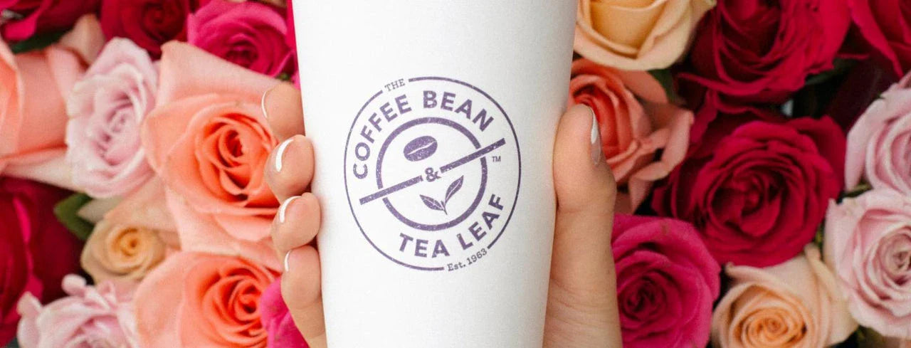 Coffee Bean and Tea Leaf cup with roses background
