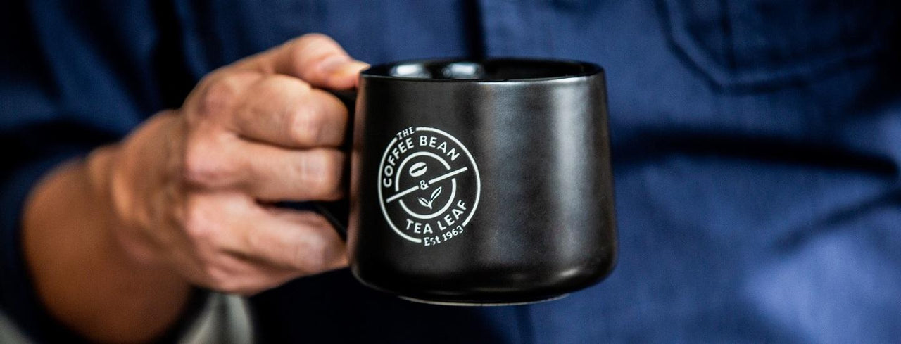 Person Holding Mug of Coffee