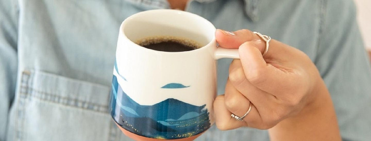 Person Holding Cup of Coffee