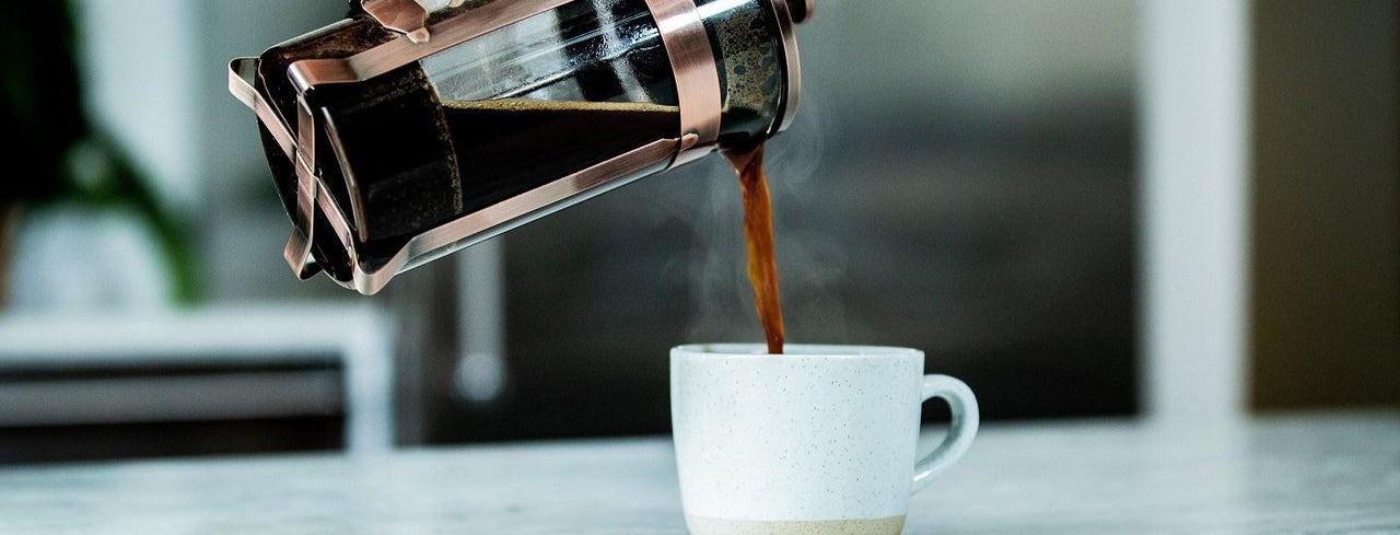 Person Pouring Coffee into mug