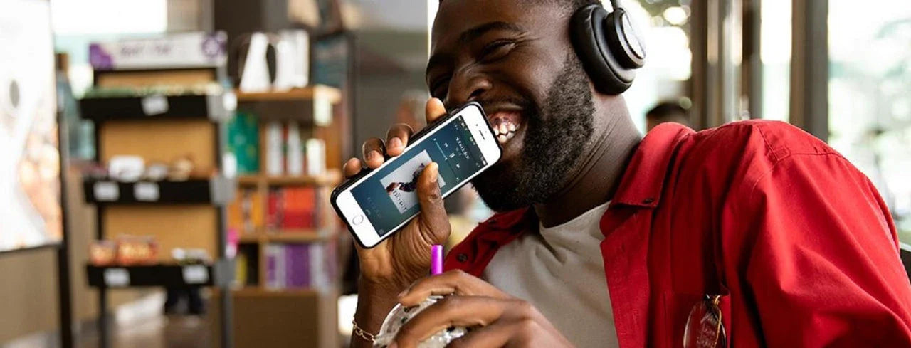 Man Holding Cup of Coffee listening to music