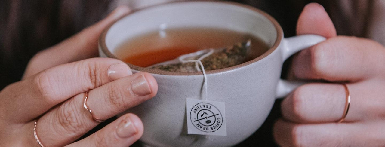 Person Holding Tea Cup