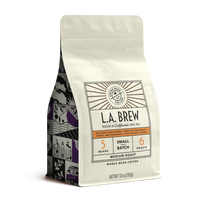 10oz cream bag labeled “L.A. Brew” on a white background. The design shows the coffee is Roasted in California, has a delicate plum aroma with hints of chocolate dates and hazelnut with a rich syrupy finish and is Medium, Ground.