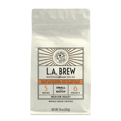 10oz cream bag labeled “L.A. Brew” on a white background. The design shows the coffee is Roasted in California, has a delicate plum aroma with hints of chocolate dates and hazelnut with a rich syrupy finish and is Medium, Ground.