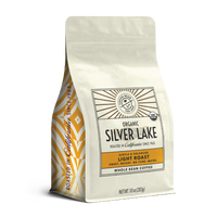 10oz cream bag labeled “Silver Lake” on a white background. The design shows the coffee is Roasted in California and has a Subtled & Balanced taste and is Light, Ground Coffee.