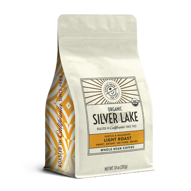 10oz cream bag labeled “Silver Lake” on a white background. The design shows the coffee is Roasted in California and has a Subtled & Balanced taste and is Light, Ground Coffee.