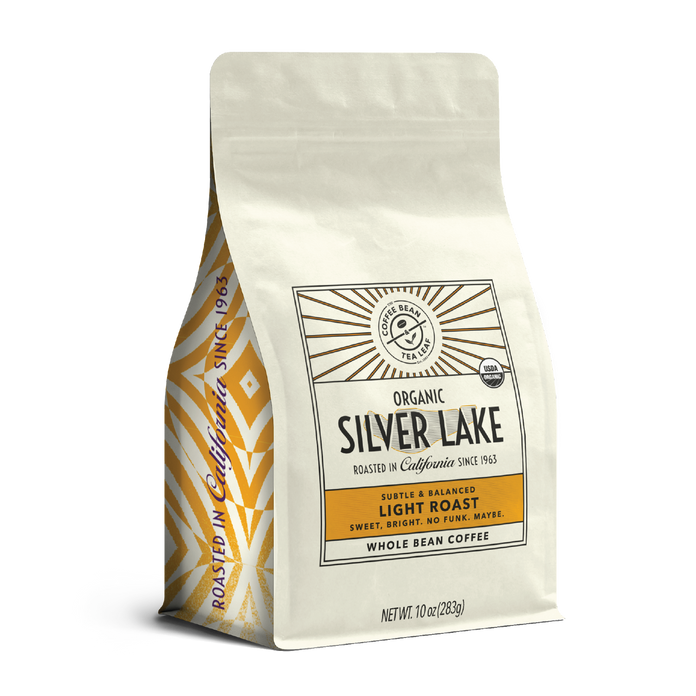 10oz cream bag labeled “Silver Lake” on a white background. The design shows the coffee is Roasted in California and has a Subtled & Balanced taste and is Light, Ground Coffee.