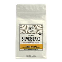 10oz cream bag labeled “Silver Lake” on a white background. The design shows the coffee is Roasted in California and has a Subtled & Balanced taste and is Light, Ground Coffee.