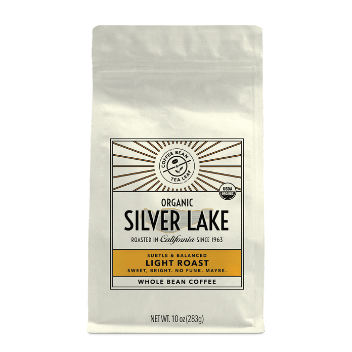 10oz cream bag labeled “Silver Lake” on a white background. The design shows the coffee is Roasted in California and has a Subtled & Balanced taste and is Light, Ground Coffee.