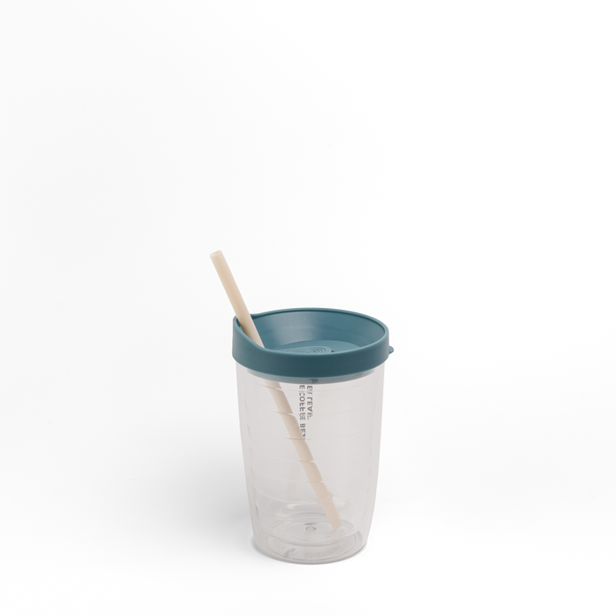 A clear plastic travel tumbler with a teal lid and a beige reusable straw, shown on a seamless white background.