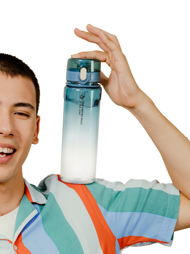 A smiling young man in a striped shirt holds up a translucent water bottle with a blue-to-white gradient design against a solid white background.