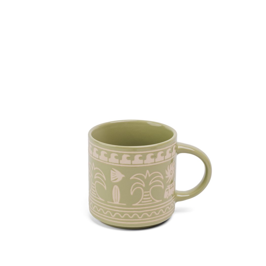 A green ceramic mug with a cream-colored hand-painted tropical pattern of palm trees, surfboards, and waves, shown on a plain white background.