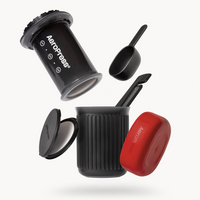 Aeropress coffee maker with red lid on a white background