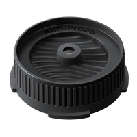 Black AeroPress coffee brewing component on a white background
