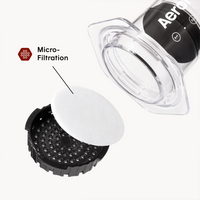 Aeropress coffee maker with a focus on micro-filtration component on a white background