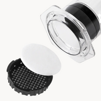 AeroPress white paper filter between the lid and of an AeroPress XL Coffee Press