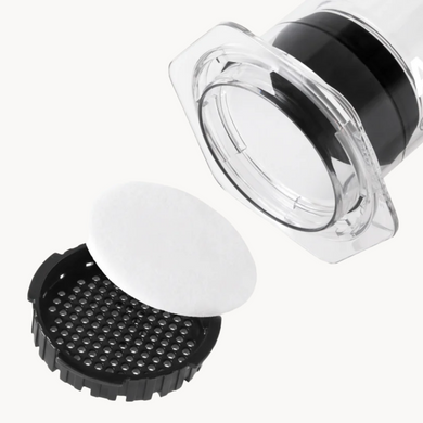AeroPress white paper filter between the lid and of an AeroPress XL Coffee Press