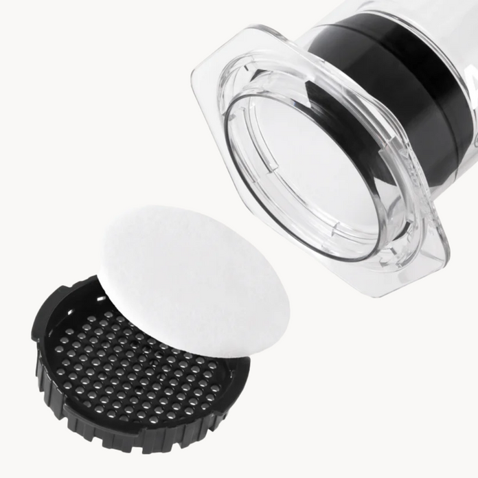 AeroPress white paper filter between the lid and of an AeroPress XL Coffee Press