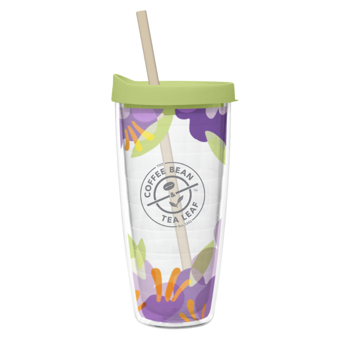 Clear tumbler with floral design and green lid on a white background