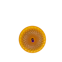 Yellow textured circular object on a white background