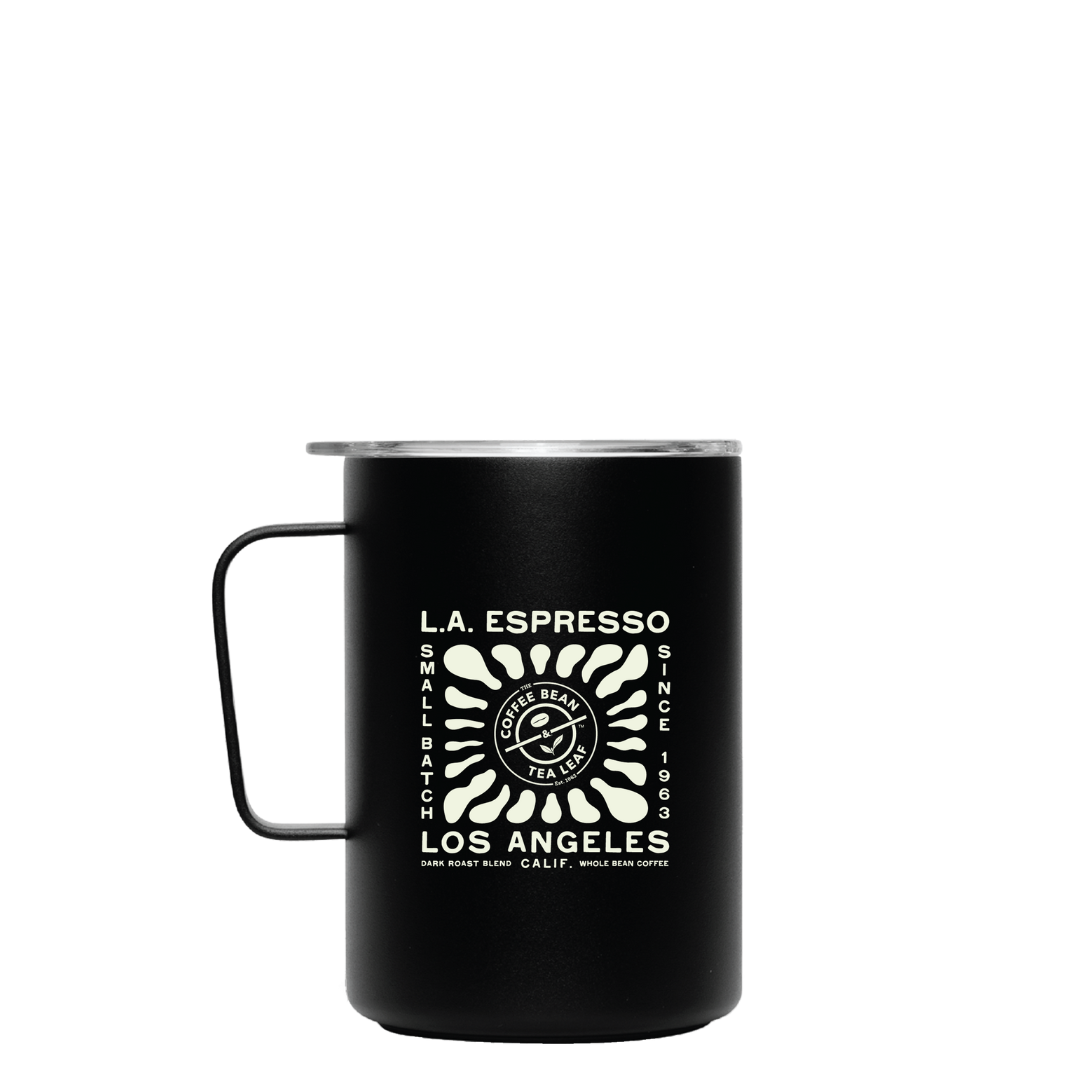 Black metal coffee mug with a lid and white design that reads 'L.A. Espresso, Small Batch, Since 1963, Los Angeles' featuring a stylized sunburst and coffee bean logo in the center.