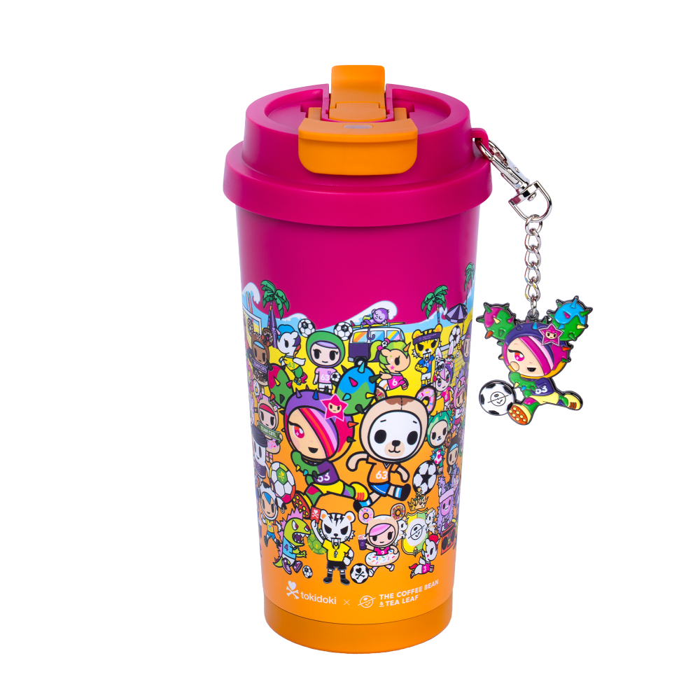 Coral colored tokidoki tumbler with flip lid, shows animated tokidoki characters on a beach